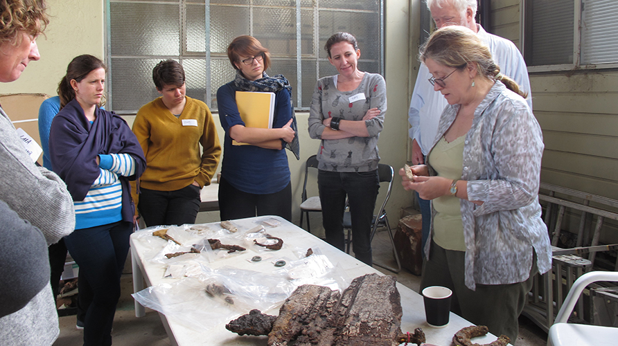 Robyn Stocks (far right) shows participants several artefacts from Barangaroo South